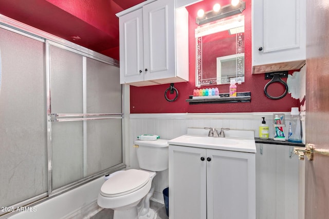 full bathroom with toilet, vanity, and shower / bath combination with glass door