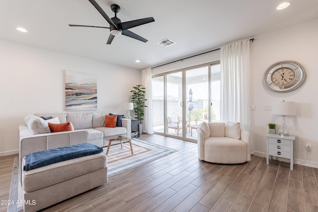 living area featuring ceiling fan and light hardwood / wood-style floors