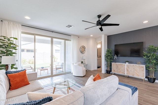 living room with ceiling fan and light wood-type flooring