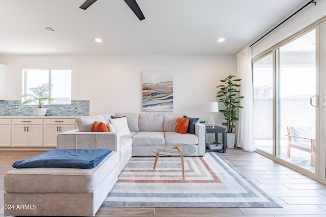 living room featuring ceiling fan and light wood-type flooring