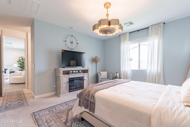 carpeted bedroom with a chandelier