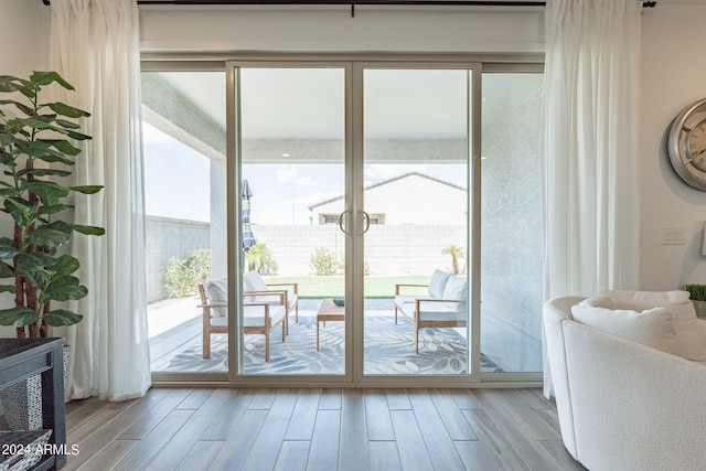 doorway to outside with light wood-type flooring