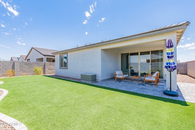 rear view of house featuring a patio area, a lawn, and cooling unit