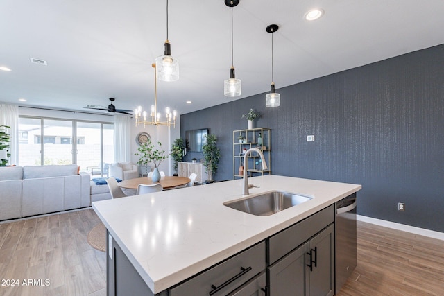 kitchen featuring sink, wood-type flooring, and gray cabinetry