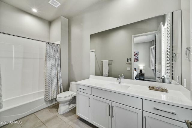 ensuite bathroom with vanity, visible vents, tile patterned flooring, shower / bath combination with curtain, and toilet