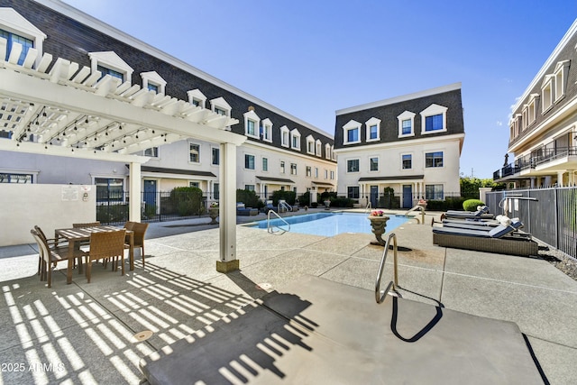 pool featuring a pergola, a patio, and fence