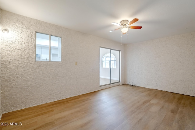 unfurnished room with light hardwood / wood-style floors and ceiling fan