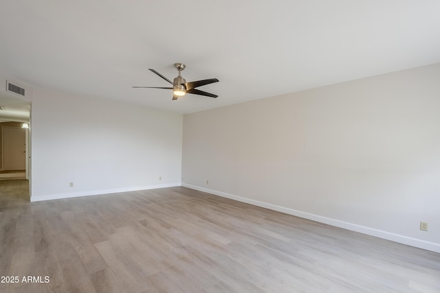 empty room with light hardwood / wood-style floors and ceiling fan