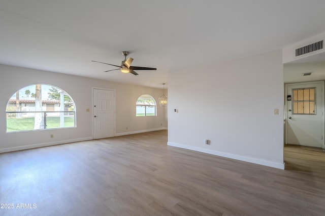 empty room featuring ceiling fan and light hardwood / wood-style flooring