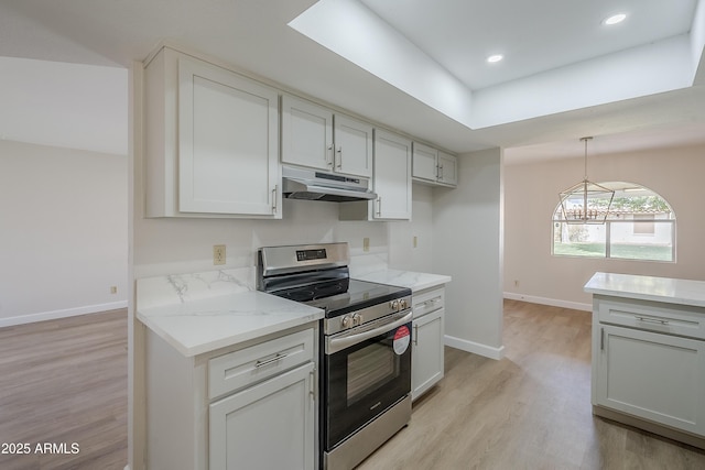 kitchen with pendant lighting, white cabinets, electric range, light stone counters, and light wood-type flooring