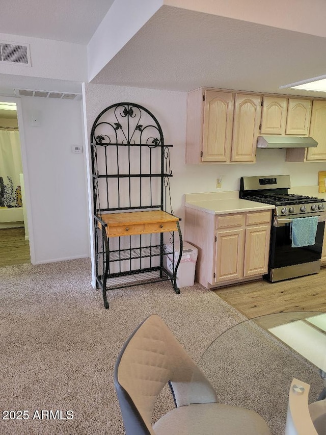 311 E Lancaster Ct, Florence, AZ 85132 - kitchen with under cabinet range hood, visible vents, gas stove, and light brown cabinetry