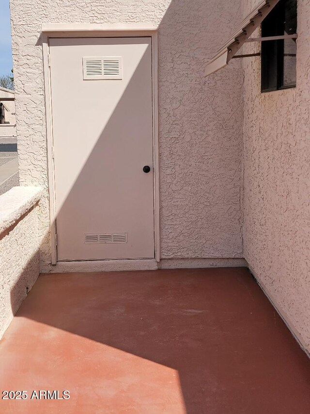 311 E Lancaster Ct, Florence, AZ 85132 - view of exterior entry featuring visible vents and stucco siding