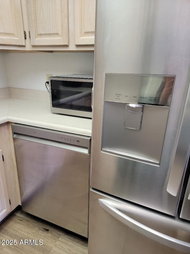 311 E Lancaster Ct, Florence, AZ 85132 - kitchen featuring light wood-style flooring, light brown cabinets, stainless steel appliances, and light countertops