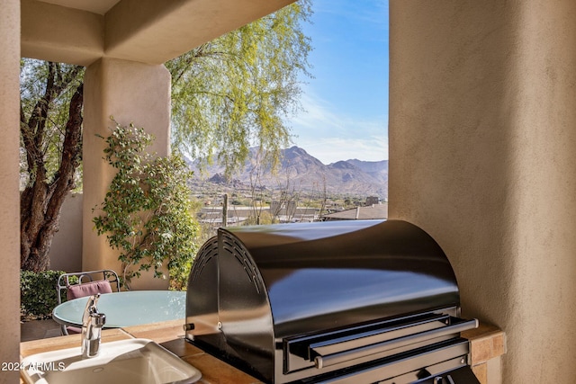 exterior space with a mountain view and a grill