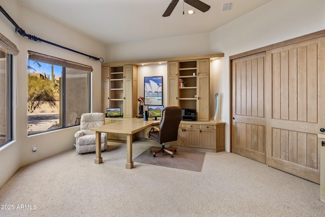 carpeted office featuring ceiling fan