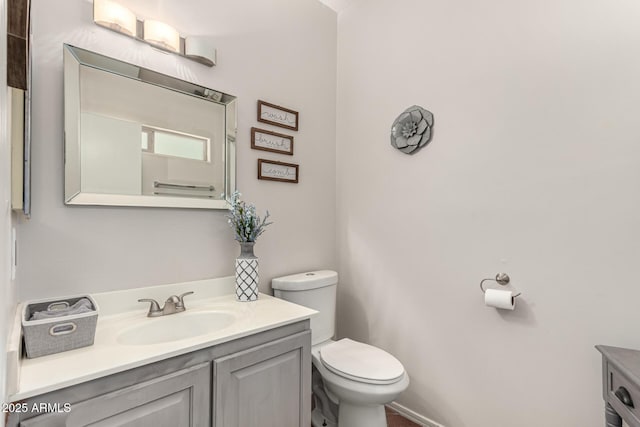 bathroom with toilet and vanity