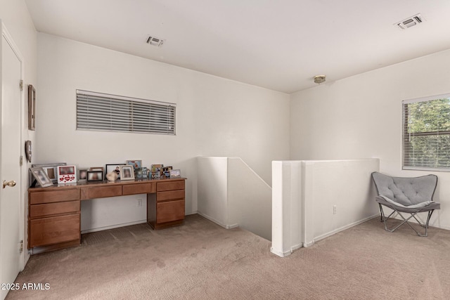 home office with visible vents and light carpet