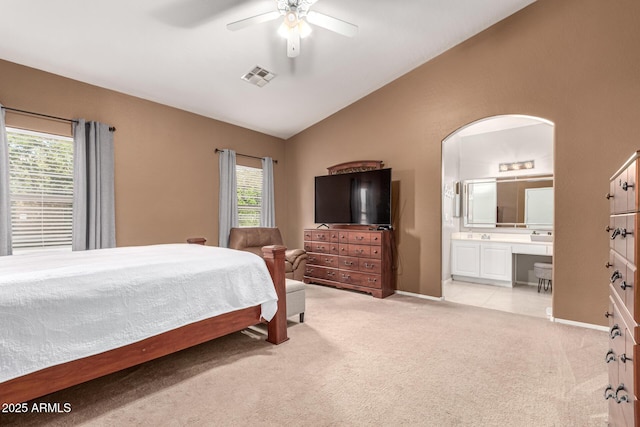 bedroom featuring baseboards, visible vents, light carpet, and vaulted ceiling