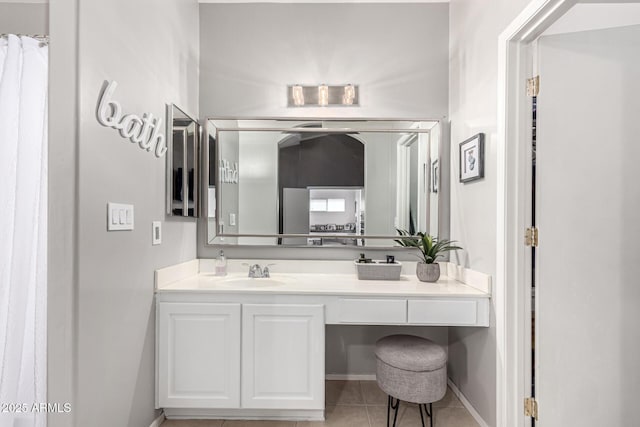bathroom with tile patterned flooring, baseboards, and vanity