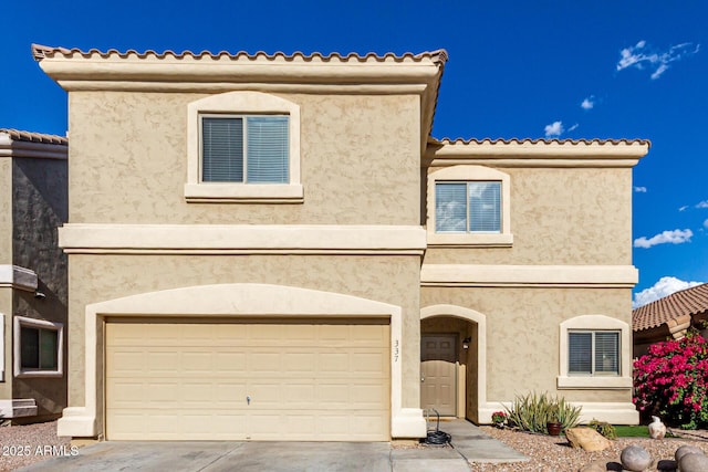 mediterranean / spanish-style home with stucco siding, concrete driveway, and a garage