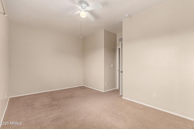 unfurnished room with light colored carpet, baseboards, ceiling fan, and visible vents