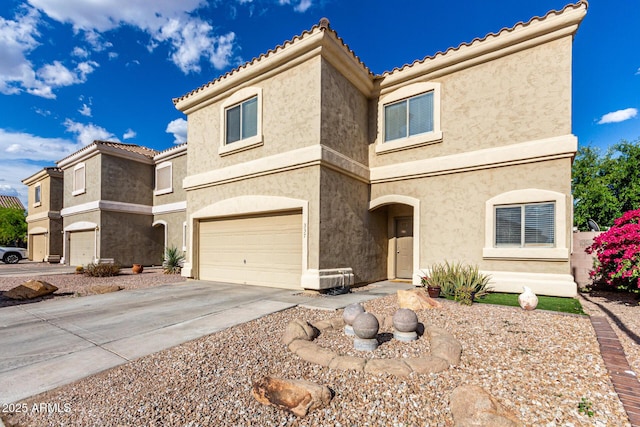 view of front facade featuring a garage, stucco siding, and driveway