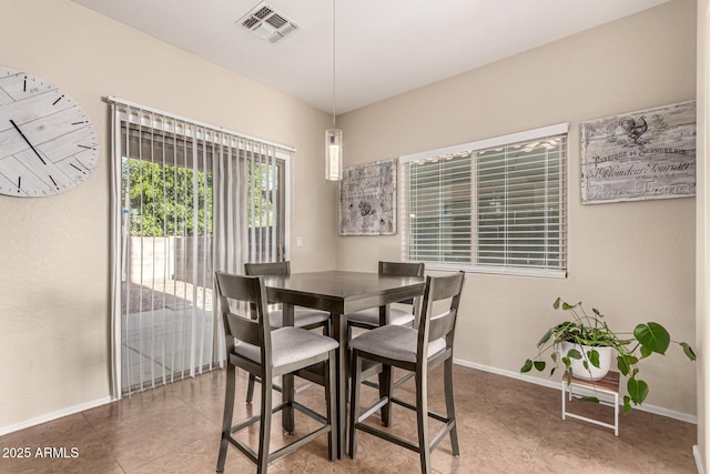 tiled dining room with visible vents and baseboards