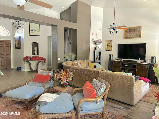 living room with a high ceiling, ceiling fan, and light hardwood / wood-style flooring