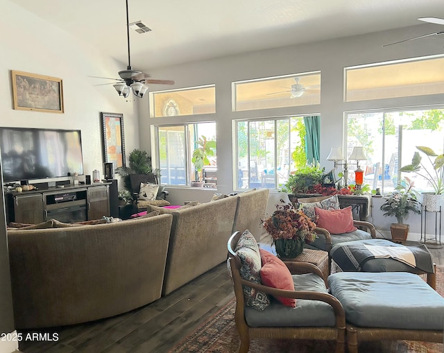 living room with a healthy amount of sunlight and dark hardwood / wood-style flooring