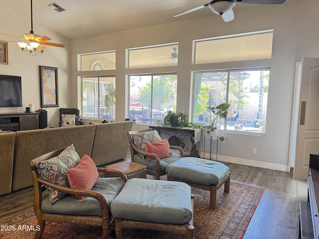 living room with vaulted ceiling, plenty of natural light, and hardwood / wood-style floors