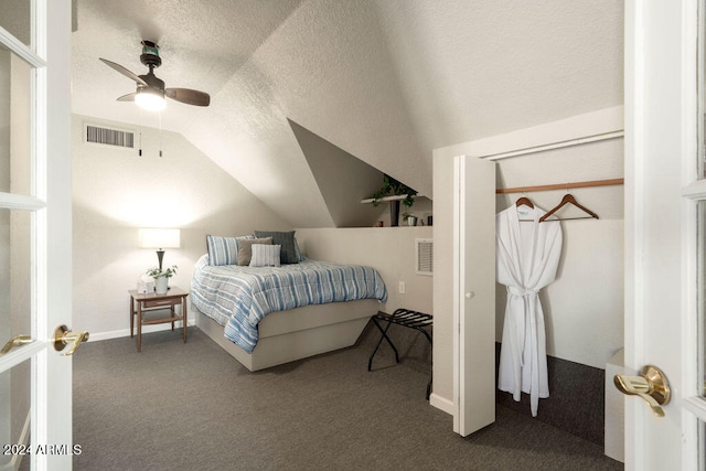 bedroom featuring a textured ceiling, carpet floors, ceiling fan, and lofted ceiling