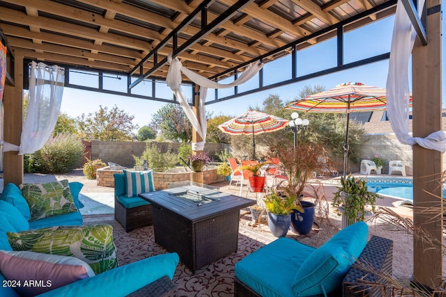 view of patio / terrace featuring a fenced in pool and an outdoor living space with a fire pit