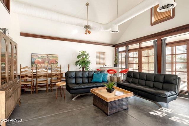 living room with french doors, a healthy amount of sunlight, and vaulted ceiling