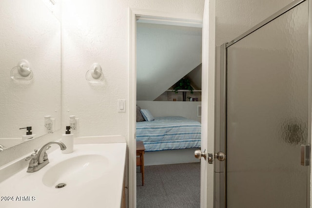 bathroom featuring sink, an enclosed shower, and lofted ceiling