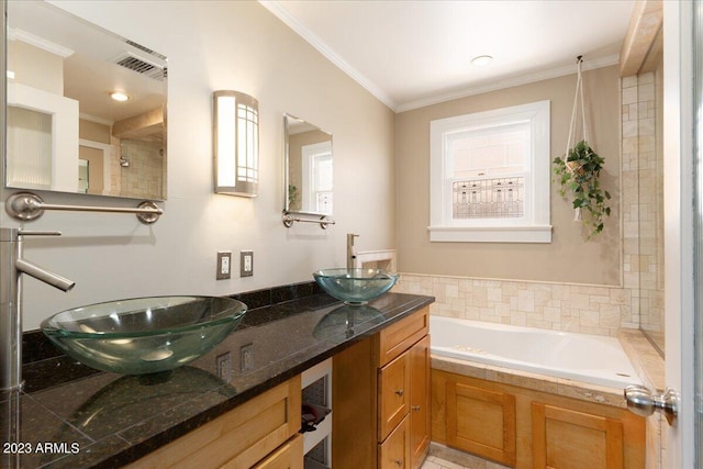 bathroom with a bath, vanity, and ornamental molding