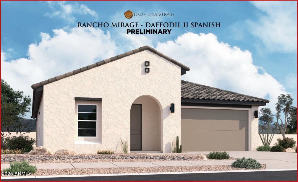 mediterranean / spanish home with concrete driveway, a tiled roof, an attached garage, and stucco siding