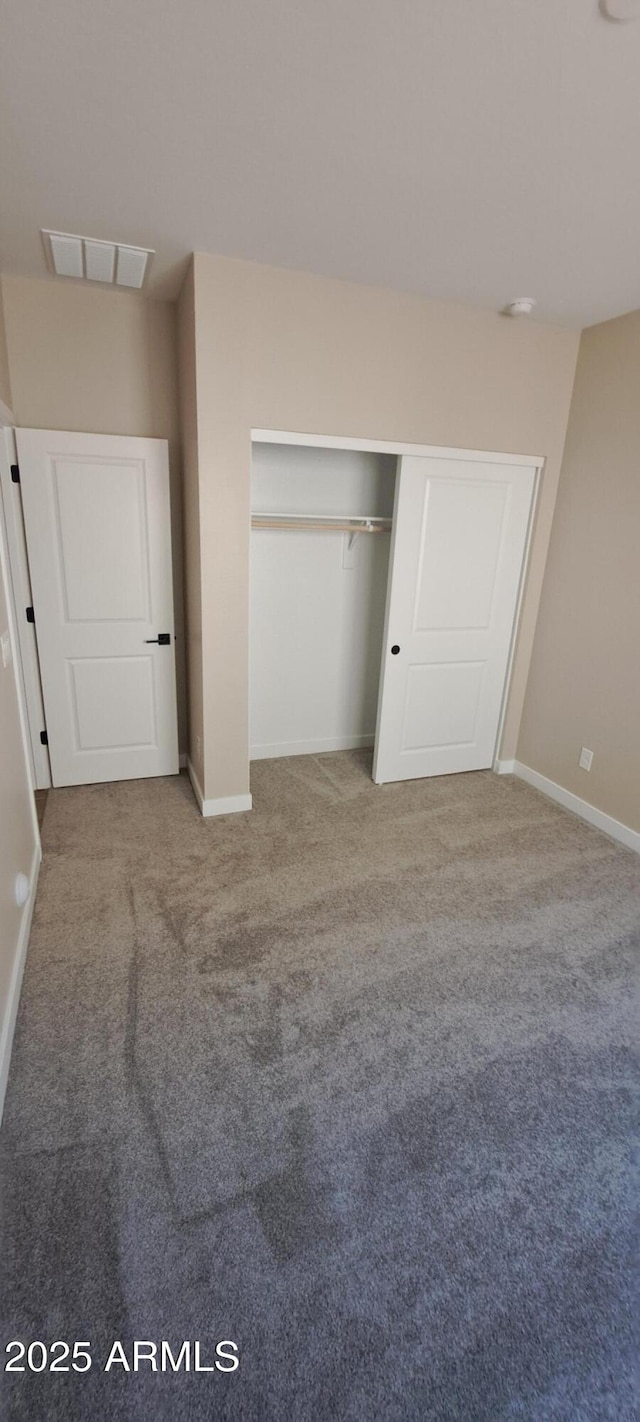 15587 S 180th Ln, Goodyear, AZ 85338 - unfurnished bedroom with carpet, baseboards, and a closet