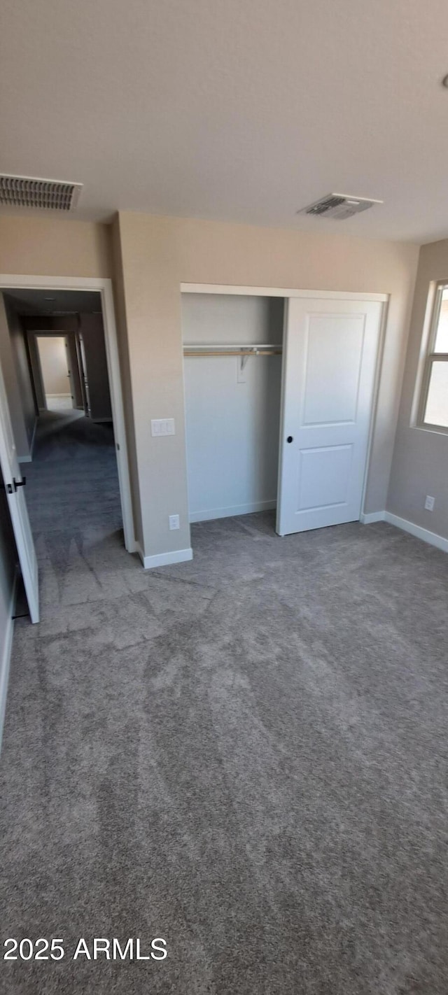 15587 S 180th Ln, Goodyear, AZ 85338 - unfurnished bedroom featuring carpet, baseboards, and a closet