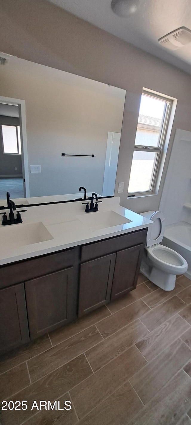 15587 S 180th Ln, Goodyear, AZ 85338 - full bath with double vanity, wood tiled floors, and toilet