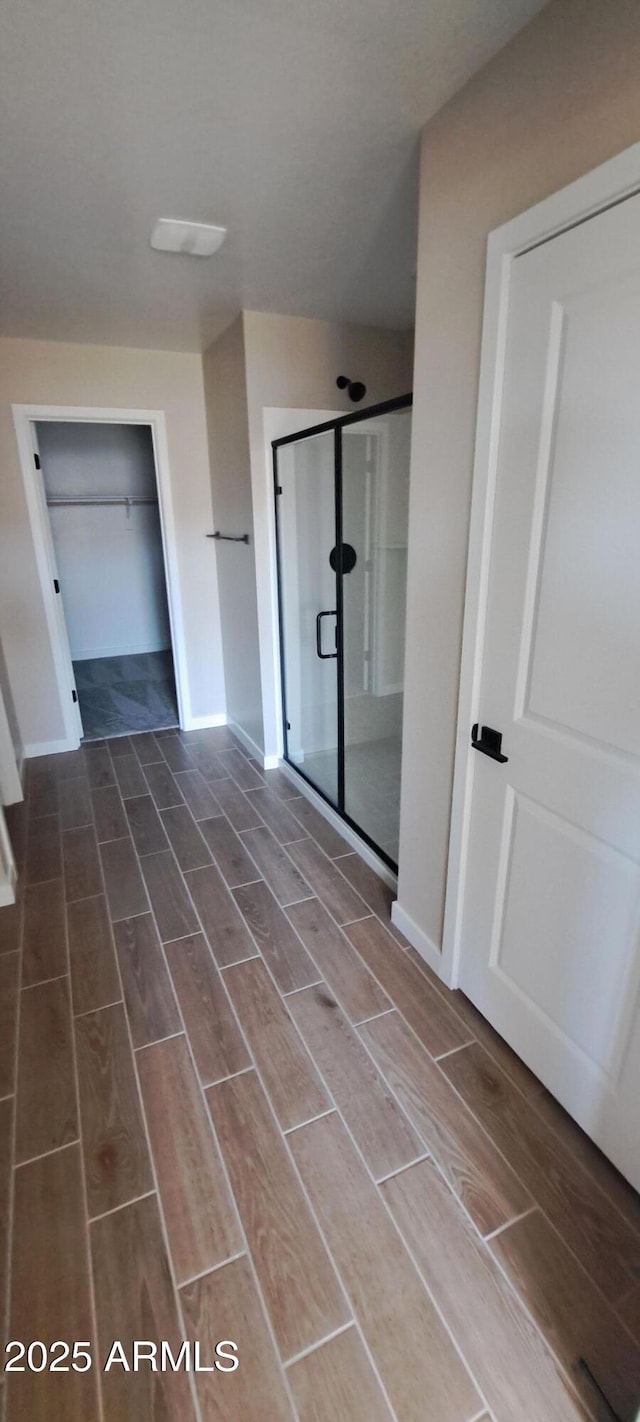 15587 S 180th Ln, Goodyear, AZ 85338 - full bathroom featuring wood finish floors, a shower stall, and baseboards