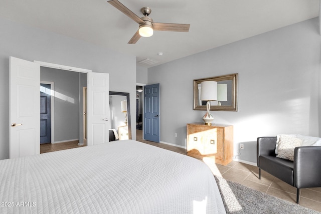 bedroom featuring a ceiling fan, visible vents, baseboards, and light tile patterned floors