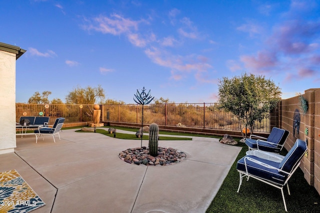 patio terrace at dusk with a fenced backyard