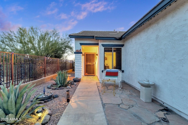 patio terrace at dusk with a fenced backyard