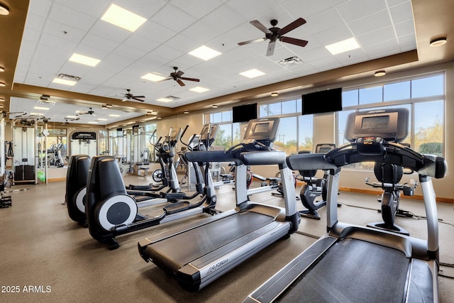 workout area featuring baseboards, visible vents, and a drop ceiling