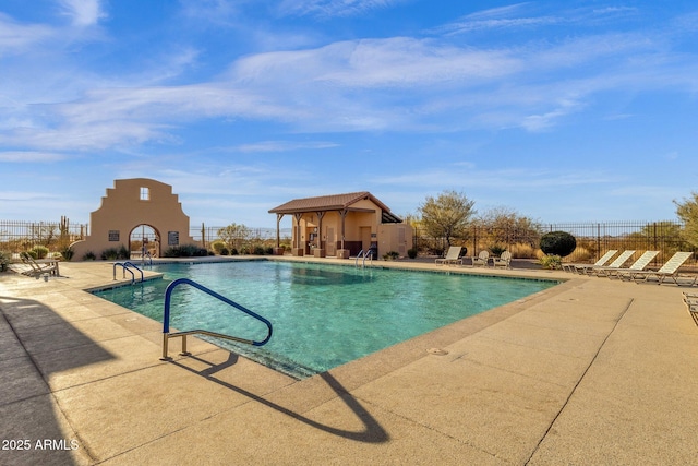 community pool featuring a patio and fence