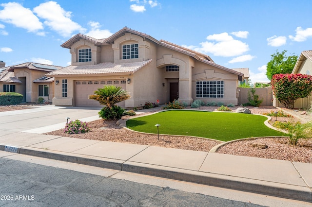 view of front of property with stucco siding, driveway, an attached garage, and a tiled roof