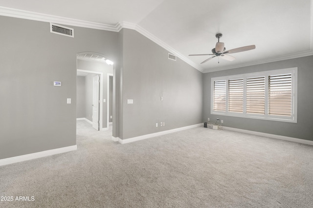 spare room with a ceiling fan, ornamental molding, carpet flooring, baseboards, and arched walkways