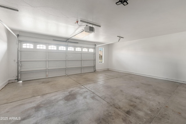 garage with baseboards and a garage door opener