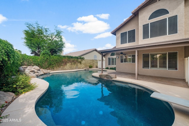 view of swimming pool with a patio area, ceiling fan, and fence