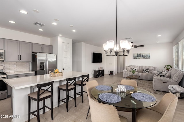 dining space with recessed lighting, visible vents, and light wood-style flooring